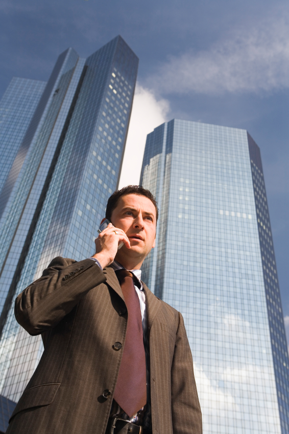 decoration image of man talking on the phone with buildings behind him