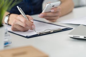 decoration image of person writting on pad on a desk